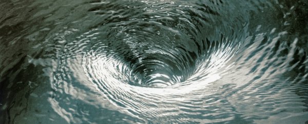Water spiralling down a drain, one of the everyday spirals the game points at